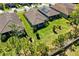 Aerial view of three homes, large manicured lawns, and surrounding landscaping and trees at 20173 Umbria Hill Dr, Tampa, FL 33647