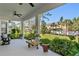 Inviting outdoor space with ceiling fans overlooking manicured lawn and mature landscaping at 20173 Umbria Hill Dr, Tampa, FL 33647
