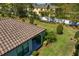 Backyard aerial featuring the home's tile roof and the covered patio in a landscaped setting at 20173 Umbria Hill Dr, Tampa, FL 33647