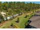 Backyard view with manicured landscaping, privacy fence, and view of the home's tiled roof at 20173 Umbria Hill Dr, Tampa, FL 33647