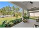 Landscaped backyard featuring a covered patio area and mature trees at 20173 Umbria Hill Dr, Tampa, FL 33647