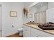 Well-lit bathroom featuring a granite countertop, white cabinetry, and decorative accents at 20173 Umbria Hill Dr, Tampa, FL 33647