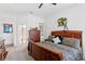 Comfortable bedroom with hardwood furniture, stylish bedding and decor, and a doorway to the bathroom at 20173 Umbria Hill Dr, Tampa, FL 33647