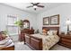 Charming bedroom with a wooden bed frame, decorative pillows, and natural light from the window at 20173 Umbria Hill Dr, Tampa, FL 33647