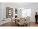 Elegant dining room featuring a wooden table set, stylish chandelier, and decorative wall mirror at 20173 Umbria Hill Dr, Tampa, FL 33647