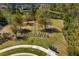 View of a fenced dog park surrounded by grassy fields, trees, and lush landscaping at 20173 Umbria Hill Dr, Tampa, FL 33647