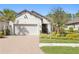 Charming one-story home with lush landscaping, brick driveway, and a two-car garage at 20173 Umbria Hill Dr, Tampa, FL 33647