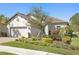 Beautiful single-story home with a well-manicured lawn and mature tree in the front yard at 20173 Umbria Hill Dr, Tampa, FL 33647