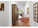 Elegant hallway featuring hardwood floors, tray ceilings, and decorative furnishings at 20173 Umbria Hill Dr, Tampa, FL 33647