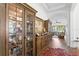 Bright hallway with display cabinet, opening up to the living area and backyard views at 20173 Umbria Hill Dr, Tampa, FL 33647