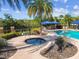 Relax in the community hot tub surrounded by tropical landscaping, shaded lounge chairs, and lush shrubbery at 20173 Umbria Hill Dr, Tampa, FL 33647