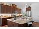 Spacious kitchen featuring stainless steel appliances, dark wood cabinets and countertop seating at 20173 Umbria Hill Dr, Tampa, FL 33647