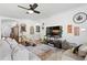 Well-lit living room with comfy seating, stylish decor, and a ceiling fan at 20173 Umbria Hill Dr, Tampa, FL 33647