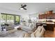 Open-concept living space connecting to kitchen, with plush seating and natural light at 20173 Umbria Hill Dr, Tampa, FL 33647