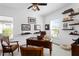 Bright home office with hardwood desk, ceiling fan, and shelving with decorative accents at 20173 Umbria Hill Dr, Tampa, FL 33647