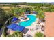 Stunning aerial view of the community pool, complete with a jacuzzi and beautiful poolside furniture at 20173 Umbria Hill Dr, Tampa, FL 33647