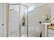 Spacious tiled shower with frameless glass door, built-in shelving, and decorative accents at 20173 Umbria Hill Dr, Tampa, FL 33647