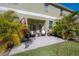 Inviting back patio with comfortable seating and lush tropical landscaping creates a relaxing outdoor oasis at 20319 Starfinder Way, Tampa, FL 33647