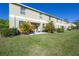 Exterior shot of the house showing a backyard with a patio and a grassy lawn at 20319 Starfinder Way, Tampa, FL 33647