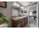 Bathroom with double sink vanity, warm cabinets, and a view of the game room at 20319 Starfinder Way, Tampa, FL 33647