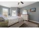 A tranquil bedroom with neutral tones, a ceiling fan and outdoor access through french doors at 20319 Starfinder Way, Tampa, FL 33647