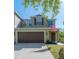 Charming two-story home featuring a two-car garage, well-maintained lawn, and traditional architectural details at 20319 Starfinder Way, Tampa, FL 33647