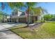 Beautiful home exterior featuring a well-manicured lawn and a driveway leading to an attached two-car garage at 20319 Starfinder Way, Tampa, FL 33647