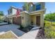 Well-kept home exterior with an attached two-car garage, neat landscaping, and a neatly paved driveway at 20319 Starfinder Way, Tampa, FL 33647