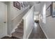 Bright and airy hallway featuring hardwood floors, white trim, staircase, and tasteful wall decor at 20319 Starfinder Way, Tampa, FL 33647