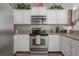 Well-equipped kitchen with stainless steel appliances, granite countertops, tile backsplash, and ample cabinet space at 20319 Starfinder Way, Tampa, FL 33647