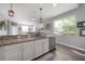 Bright kitchen featuring granite countertops, modern fixtures, stainless appliances, and seamless flow to the living area at 20319 Starfinder Way, Tampa, FL 33647
