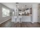 Bright kitchen with a breakfast bar, white cabinets, stainless steel appliances and wood-look flooring at 20319 Starfinder Way, Tampa, FL 33647