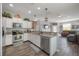 Modern kitchen with white cabinets, granite countertops, stainless steel appliances, and open layout to living area at 20319 Starfinder Way, Tampa, FL 33647