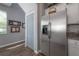 Spacious kitchen featuring stainless steel refrigerator, ample cabinetry, granite countertops, and tile backsplash at 20319 Starfinder Way, Tampa, FL 33647