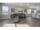 Spacious living room featuring wood-look floors, neutral paint, and a comfortable sectional at 20319 Starfinder Way, Tampa, FL 33647