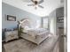 Cozy main bedroom with a plush bed, soft rug, and a ceiling fan at 20319 Starfinder Way, Tampa, FL 33647