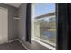 Bedroom window framing a picturesque lake view, complemented by dark curtains for privacy at 20319 Starfinder Way, Tampa, FL 33647