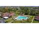 Aerial view of community with a pool, shuffleboard court, landscaping, and covered parking at 2260 Oak Neck Rd # B, Clearwater, FL 33763