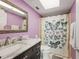 Bathroom with marble countertop vanity, toilet, and butterfly-themed shower curtain at 2260 Oak Neck Rd # B, Clearwater, FL 33763