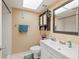 Bathroom features a skylight, shower, vanity with decor, and a neutral color scheme at 2260 Oak Neck Rd # B, Clearwater, FL 33763