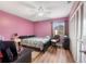 Cozy bedroom with laminated floors, ceiling fan, closet, and natural light at 2260 Oak Neck Rd # B, Clearwater, FL 33763