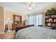 Bright bedroom with ceiling fan, light-colored walls, wood floors, dresser with mirror, and natural light at 2260 Oak Neck Rd # B, Clearwater, FL 33763