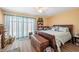 Well-lit bedroom features a large bed, ceiling fan, and a bookshelf with bright natural light at 2260 Oak Neck Rd # B, Clearwater, FL 33763