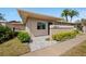 Inviting condo exterior with well-maintained landscaping, a neutral color palette, and stylish stone pavers at 2260 Oak Neck Rd # B, Clearwater, FL 33763