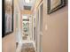 Hallway leading to bathroom with butterfly shower curtain and neutral tones at 2260 Oak Neck Rd # B, Clearwater, FL 33763