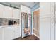 Bright kitchen features white cabinets, stainless steel appliances, and updated backsplash at 2260 Oak Neck Rd # B, Clearwater, FL 33763