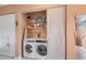 Functional laundry area with modern washer and dryer, neatly tucked away with closet shelving at 2260 Oak Neck Rd # B, Clearwater, FL 33763
