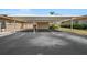 A covered parking area for residents, featuring landscaping, flowers, and green shrubbery at 2260 Oak Neck Rd # B, Clearwater, FL 33763