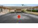 Community parking area featuring covered parking spots with flower beds and landscaping at 2260 Oak Neck Rd # B, Clearwater, FL 33763