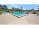 Inviting community pool with clear blue water, lounge chairs, and umbrellas for relaxing by the poolside at 2260 Oak Neck Rd # B, Clearwater, FL 33763